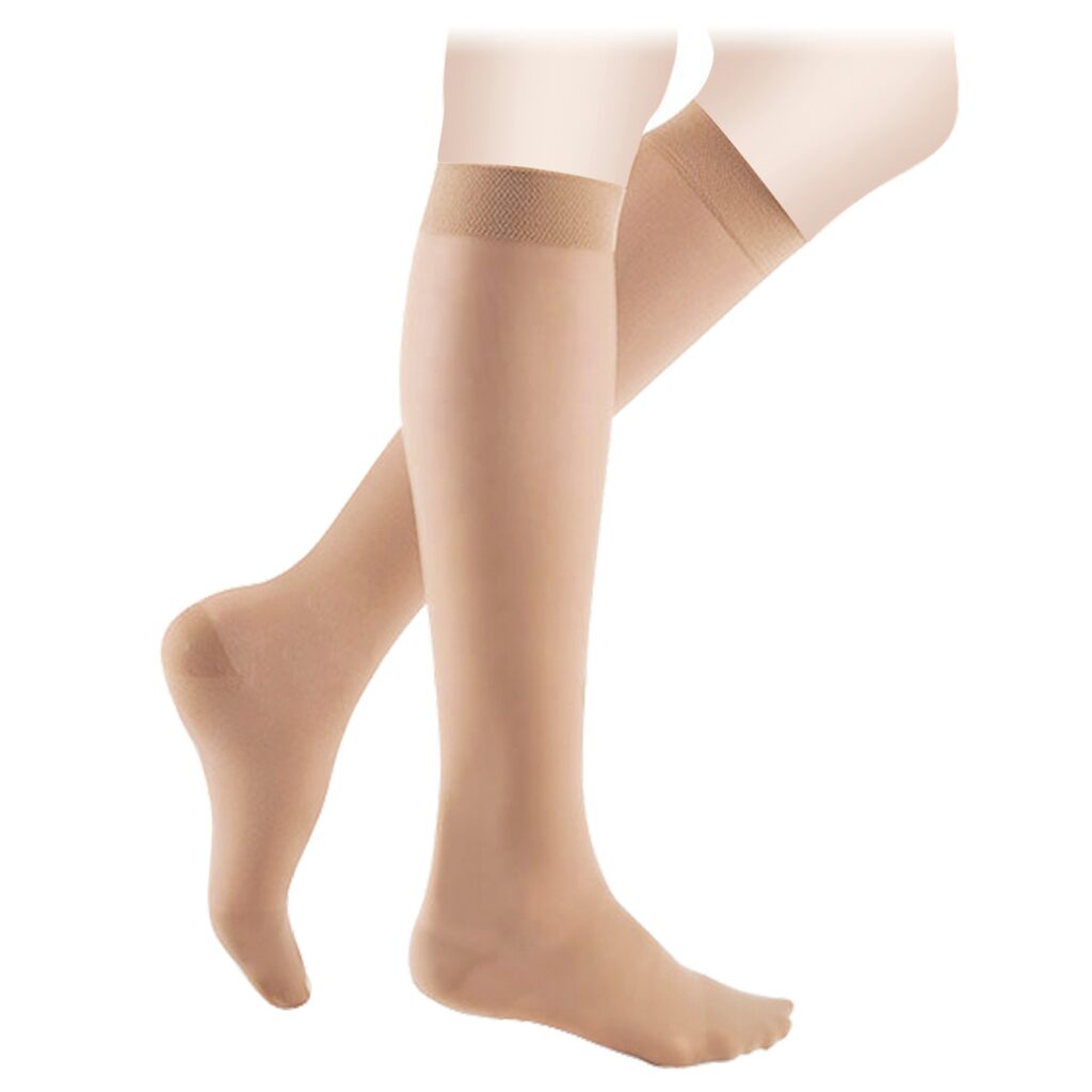 Compression socks, also referred to as compression stockings, shown on two legs and feet.